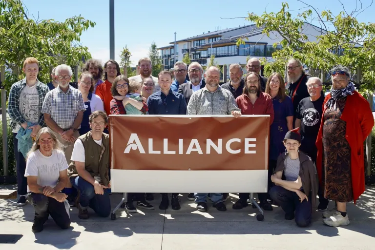 Alliance supporters gathered behind an Alliance banner