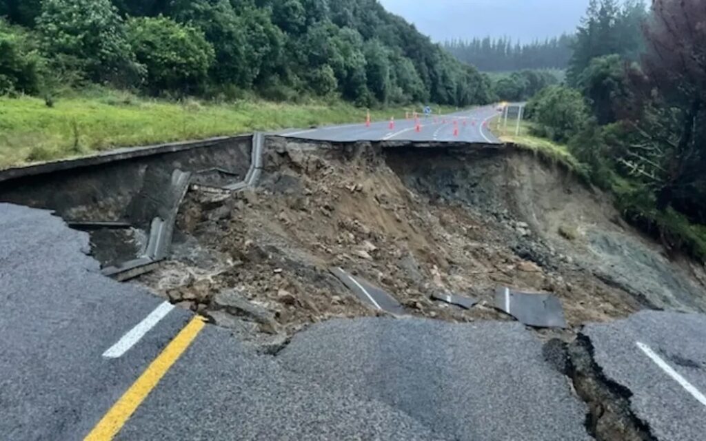 Highway washout A washed-out rural road with a collapsed carriageway and exposed embankment.