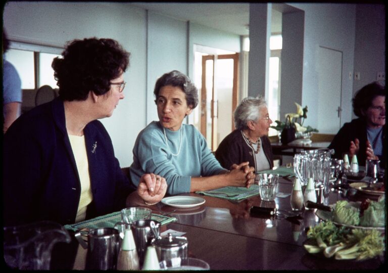 Women talking at a meal table in the dining room at Selwyn Village, Auckland, in 1967